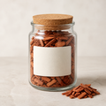 Warm red cedar chips in a clear glass jar