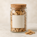 Golden sandalwood chips in a clear glass jar
