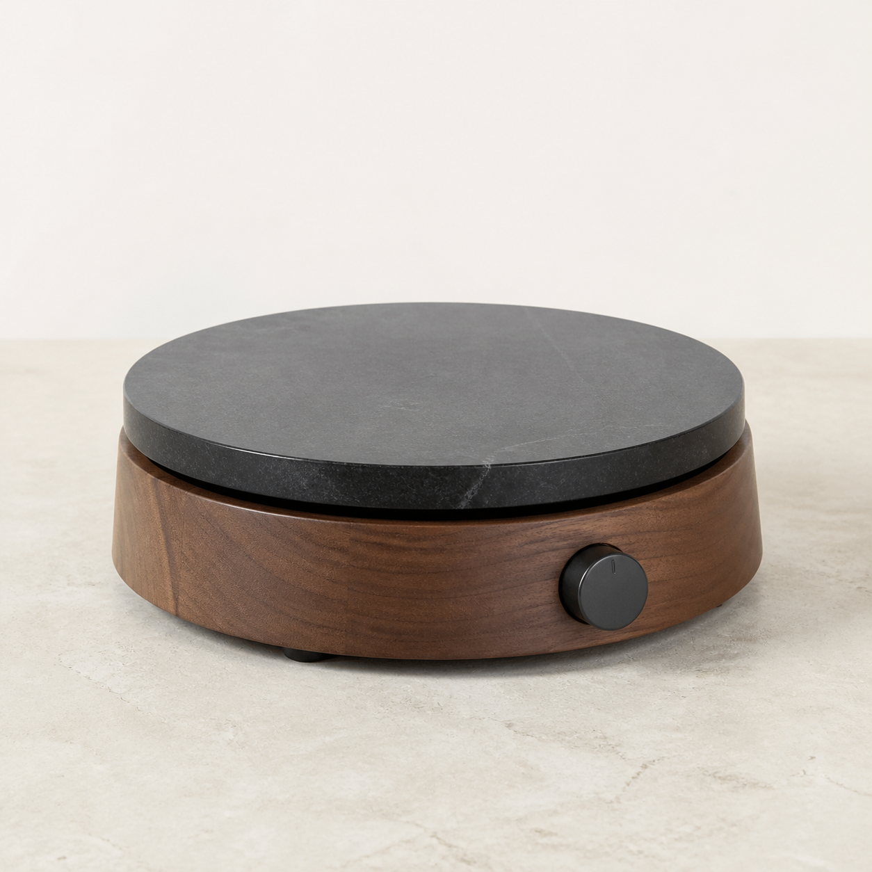 Dark stone electric warming plate on a walnut base